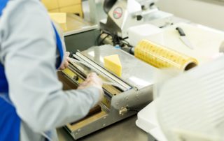 Package,Of,Cheese,Wrapped,In,Plastic,In,The,Supermarket.